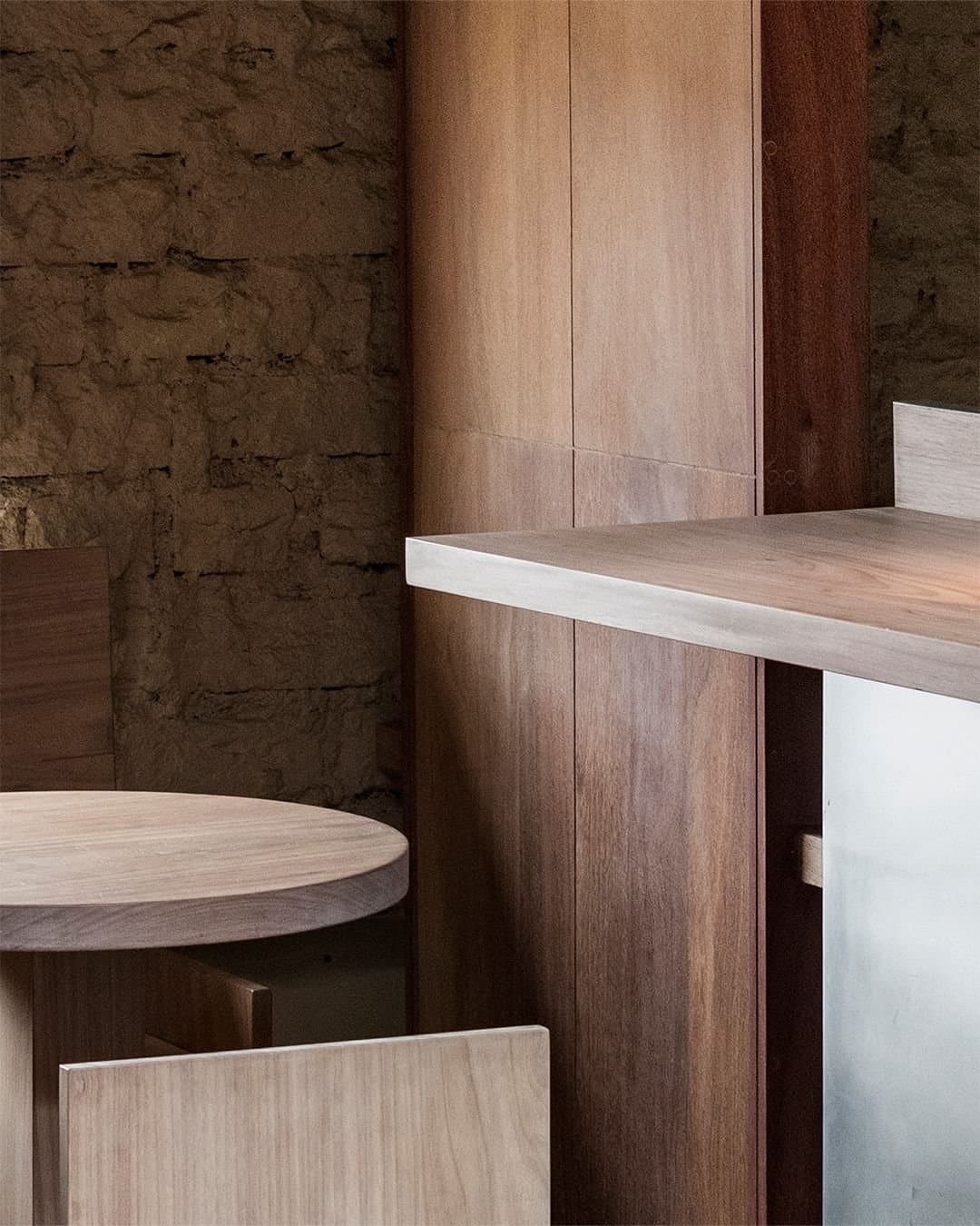 Solid cut shihuahuaco and cachimbo timber panels are layered with adobe and stainless steel. Cafe and bar in Lima, Peru. 202...